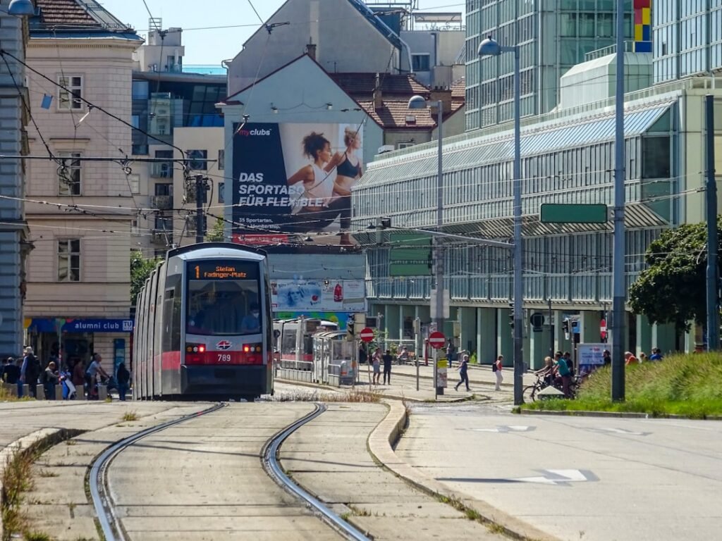 A tram travels on tracks in a city street