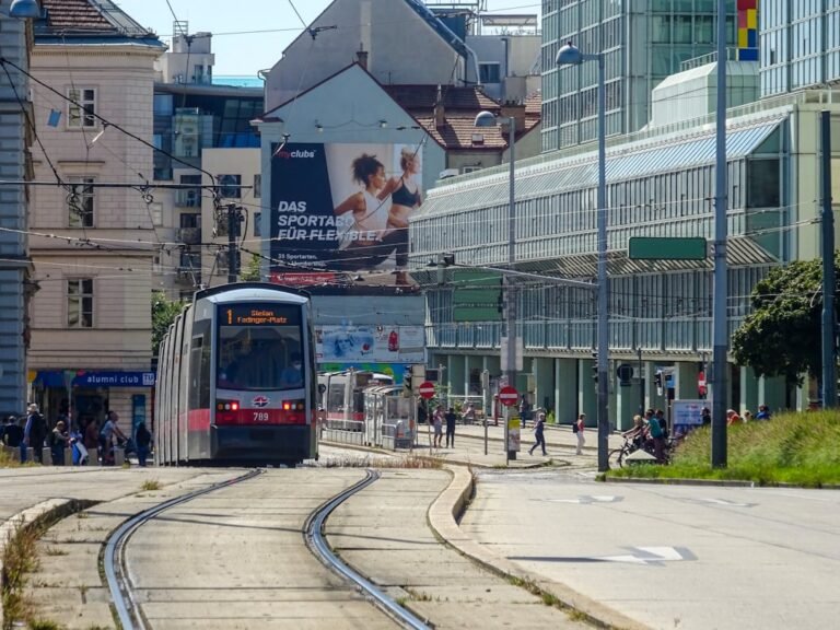 A tram travels on tracks in a city street